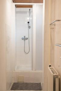 a bathroom with a shower with a glass door at Vila Mala Marta in Tatranská Lomnica