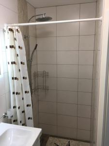 a bathroom with a shower curtain and a sink at SONNENSEITE 2 in Laboe +18 photos