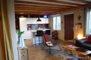 a living room with a couch and a kitchen at The Vianden Cottage - Charming Cottage in the Forest in Vianden