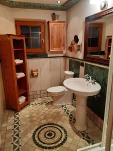 a bathroom with a toilet and a sink at Alpenchalet in Steinberg am Rofan