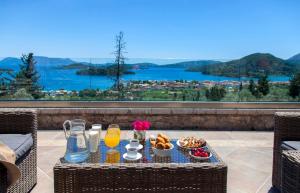 a table with food and drinks on a balcony with a view at Villa Kallisto in Nydri