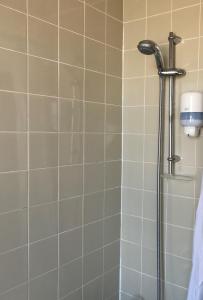 a shower with a shower head in a bathroom at Stotfield Hotel in Lossiemouth