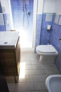 a bathroom with a toilet and a sink and a shower at Nicola's Apartments in Marina di Campo