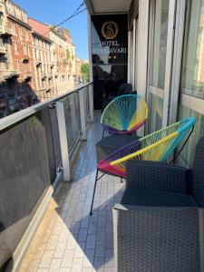 two chairs and tables on a balcony of a building at Hotel Stradivari in Milan