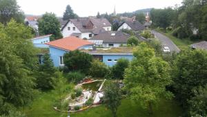 a house with a garden in the middle of a village at Ferienwohnung-Panoramablick in Gemünden an der Wohra