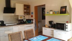 a kitchen with a table and a microwave at Ferienwohnung-Panoramablick in Gemünden an der Wohra