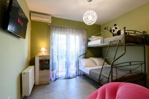a small room with a bunk bed and a television at villa elena in Preveza