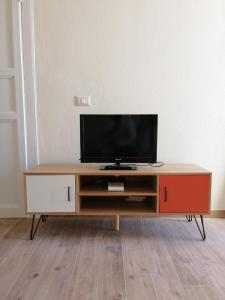 a entertainment center with a television on top of it at Casa MELA in Palau