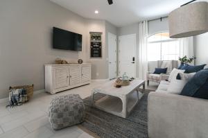 a living room with a couch and a tv at Mesa Palms Ferro townhouse in Mesa