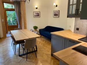 a kitchen and living room with a table and a couch at willa ella in Zakopane