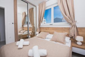 a bedroom with two beds and a large window at Fantasy Pool Villa in Novalja