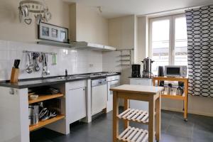 a kitchen with a sink and a stove top oven at De Oude School in Visé