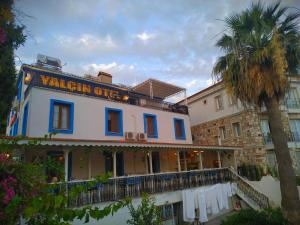 a building with a sign that reads vhemien office at Yalcin Hotel in Çeşme