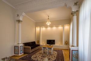 a living room with a couch and a table at Artdecoathens in Athens