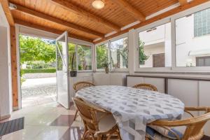 a dining room with a table and chairs at Apartman Lana in Baška +10 photos