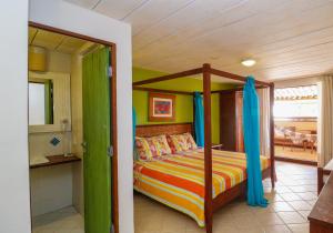 a bedroom with a bed with a canopy at Sobrado da Vila Hotel in Praia do Forte