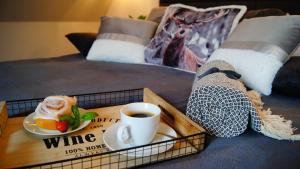 a tray of food and a cup of coffee on a bed at SKALNA CHATA 150 m do Term, Basen in Białka Tatrzańska