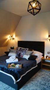 a bedroom with a large bed with a tray on it at SKALNA CHATA 150 m do Term, Basen in Białka Tatrzańska