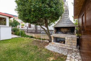 a brick fireplace on the side of a house at Apartman Lana in Baška