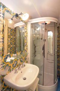 a bathroom with a sink and a shower at La Locanda Del Fiordo in Furore