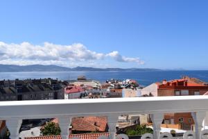 a view of a city from a balcony at Apartamentos VIDA Versus in Sanxenxo