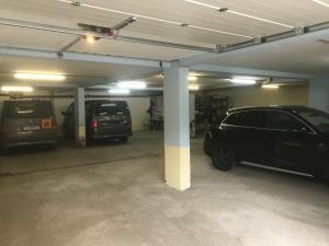 a parking garage with two cars parked in it at Gasthof Geraerhof in Vals