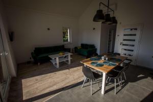 a living room with a table and a couch at Pike Fishing Camp in Nadole +8 photos