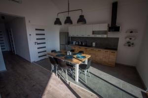 a kitchen with a wooden table and some chairs at Pike Fishing Camp in Nadole
