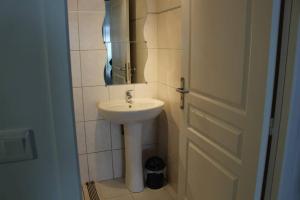 a bathroom with a sink and a mirror next to a door at STUDIO MEUBLE 30 M2 LA LONDE LES MAURES , 900 M DES PLAGES in La Londe-les-Maures