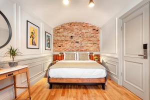 a bedroom with a bed and a brick wall at World House Boutique Hotel Galata in Istanbul