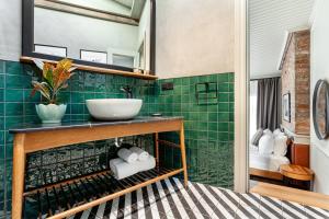 a bathroom with a sink and green tiles at World House Boutique Hotel Galata in Istanbul