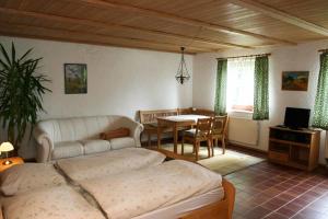 a bedroom with a bed and a dining room with a table at Angela Steiger in Bad Griesbach