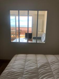 a bed in a room with a large mirror at Les tamaris in Saint-Brevin-les-Pins