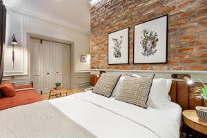 a bedroom with a white bed and a brick wall at World House Boutique Hotel Galata in Istanbul