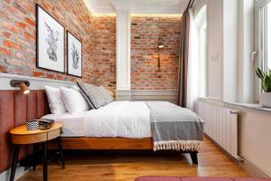 a bedroom with a bed and a brick wall at World House Boutique Hotel Galata in Istanbul
