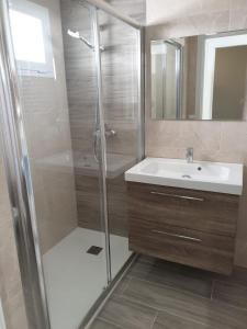 a bathroom with a shower and a sink at Playa Fontanilla Apartments in Marbella