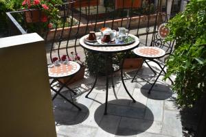 a table with two chairs and a table with food on it at Bed and Breakfast Le petunie in Bari Sardo