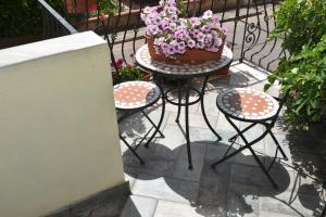 eine Terrasse mit einem Tisch und einem Kuchen darauf in der Unterkunft Bed and Breakfast Le petunie in Bari Sardo