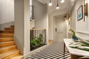 a hallway with a staircase with a fish tank in the wall at World House Boutique Hotel Galata in Istanbul