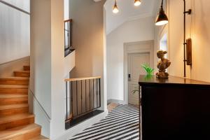 a hallway with a staircase with a black and white rug at World House Boutique Hotel Galata in Istanbul
