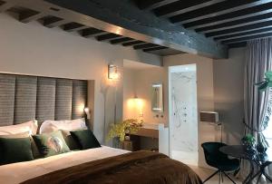 a bedroom with a large bed and a bathroom at Suite Londen66 in Den Bosch