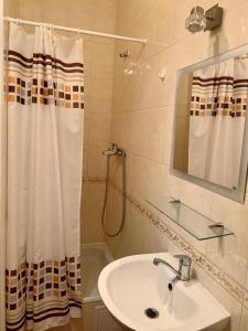 a bathroom with a sink and a shower curtain at Комфортабельный коттедж in Svityazʼ