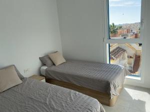 A bed or beds in a room at Playa Flamenca - Turquesa del Mar - great sea view!