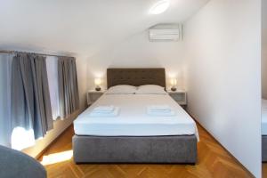 a bedroom with a large bed in a room at Apartmaji pri Perotu in Izola