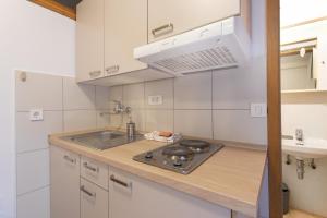 a kitchen with a stove and a sink at Apartmaji pri Perotu in Izola +24 photos