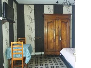プゾージュにあるchambre meublée à louerのテーブルと木製のドアが備わる部屋
