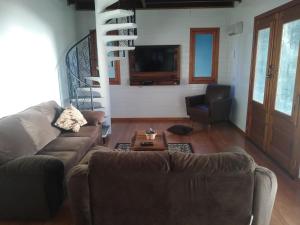 a living room with a couch and a table at CASA TEMPORADA SANTO ANTONIO in Urubici