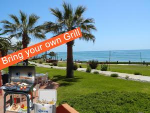 a street sign that reads bring your own grill at Puerto Nuevo Baja Hotel & Villas in Rosarito