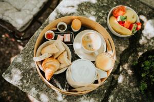 a basket of food with eggs and bread on a table at Le Moulin Camoula in Saint-Jeannet