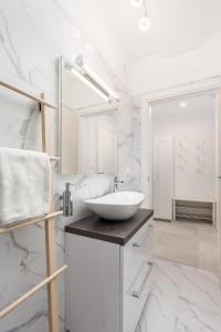 a white bathroom with a sink and a mirror at Srnec Apartments - Korzo in Rijeka